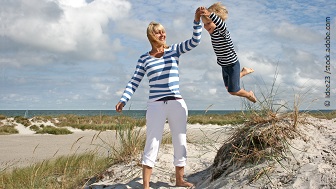 Eine Frau mit ihrem Kind am Strand.