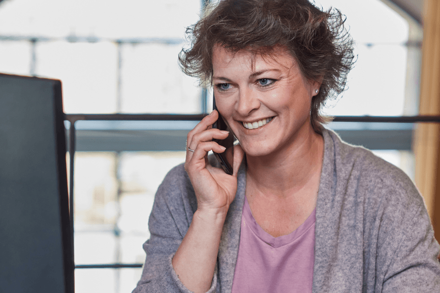 Julia telefoniert – sie teilt ihre Erfahrungen rund um Neurodermitis im Arbeitsalltag und mit der Familie